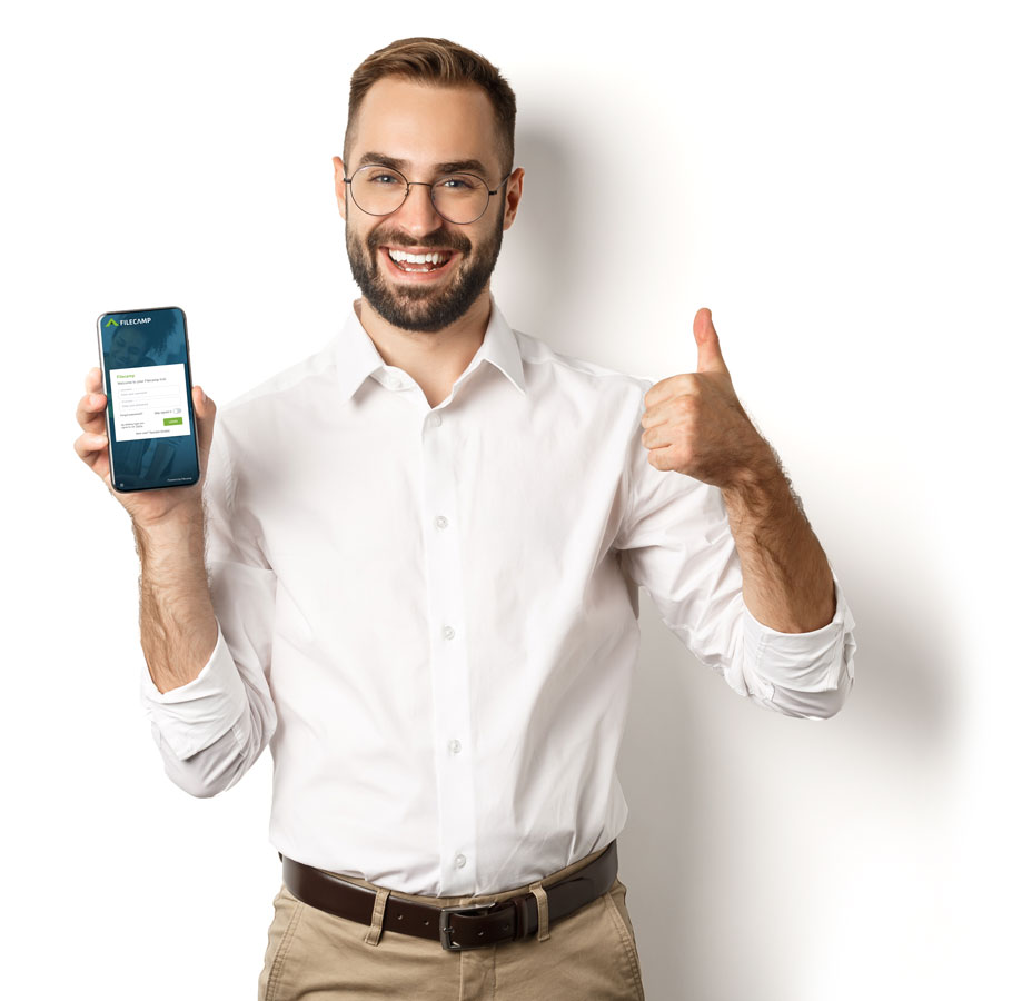 Smiling man showing smartphone with Filecamp app and giving thumbs up.